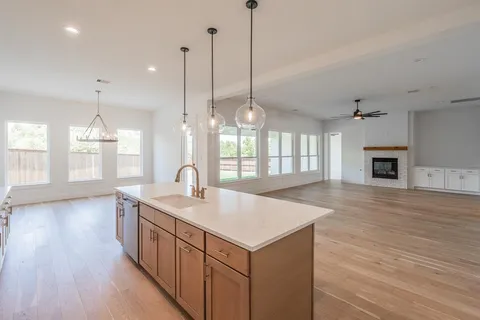 a kitchen with sink refrigerator and window