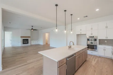 a kitchen with kitchen island a sink stainless steel appliances and cabinets