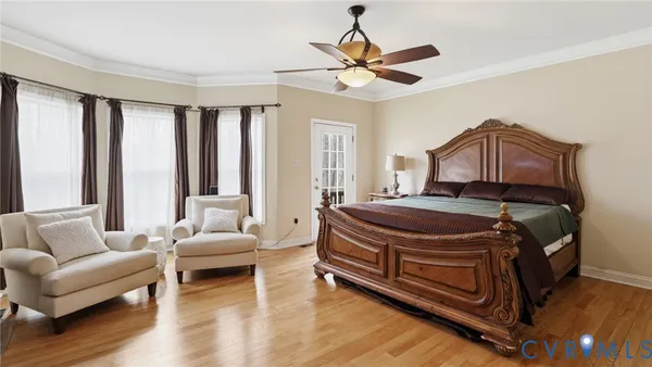 a bedroom with a bed couch and window