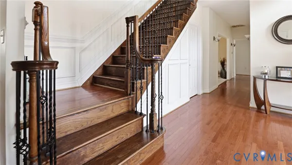 a view of entryway and hall with wooden floor