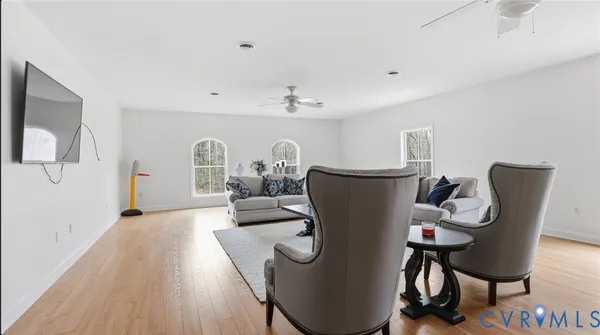 a living room with furniture a rug and white walls