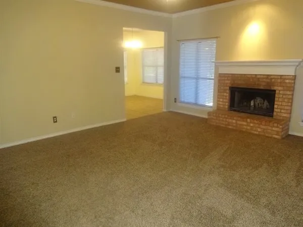 a view of an empty room with a fireplace