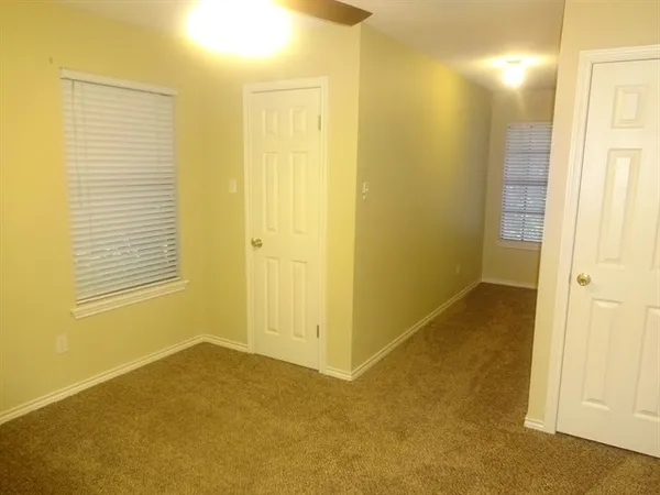 a view of an empty room with windows