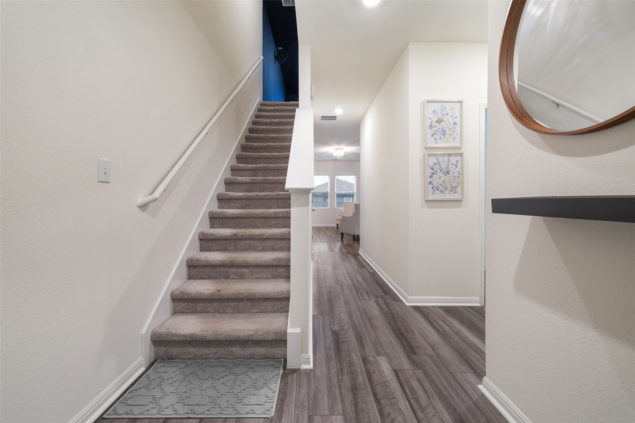 261 Night Riders Way Jarrell, TX 76537 - Photo 5 of 6 A grand staircase with plush carpeted treads welcomes guests into this elegant entry hall.