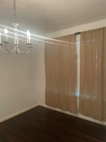 a view of a room with wooden floor and windows