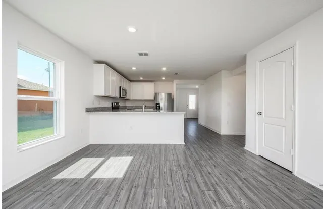 a view of kitchen with stainless steel appliances refrigerator microwave and stove