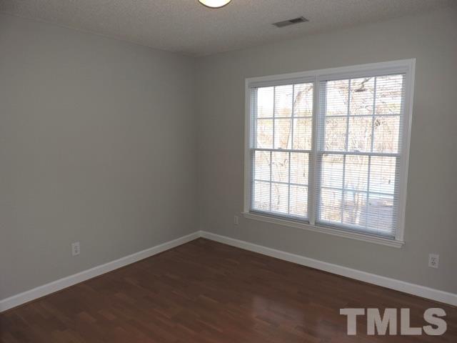 4325 Willow Lake Road Raleigh, NC 27616 - Photo 14 of 25 an empty room with wooden floor and windows