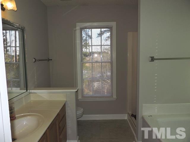 4325 Willow Lake Road Raleigh, NC 27616 - Photo 16 of 25 a bathroom with a granite countertop sink and a bathtub