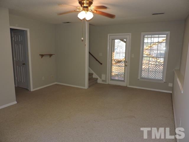 4325 Willow Lake Road Raleigh, NC 27616 - Photo 18 of 25 an empty room with windows and chandelier fan