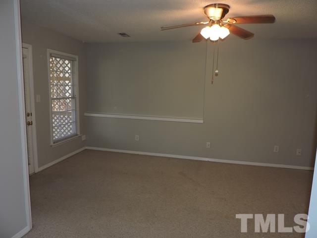 4325 Willow Lake Road Raleigh, NC 27616 - Photo 19 of 25 an empty room with windows and fan