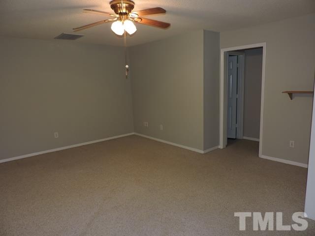 4325 Willow Lake Road Raleigh, NC 27616 - Photo 20 of 25 an empty room with a chandelier fan and windows