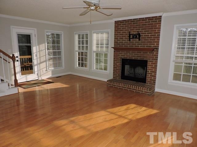 4325 Willow Lake Road Raleigh, NC 27616 - Photo 4 of 25 a view of empty room with wooden floor and fireplace