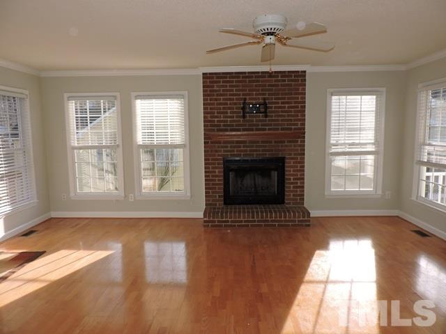 4325 Willow Lake Road Raleigh, NC 27616 - Photo 5 of 25 a view of an empty room with exposed radiator and fireplace