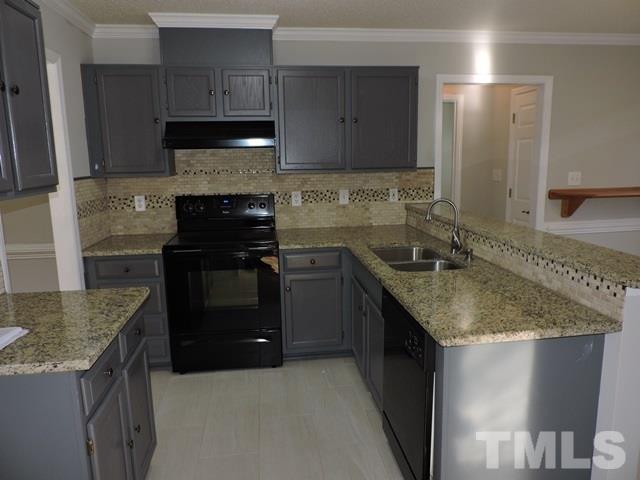 4325 Willow Lake Road Raleigh, NC 27616 - Photo 7 of 25 a kitchen with a sink stove and cabinets
