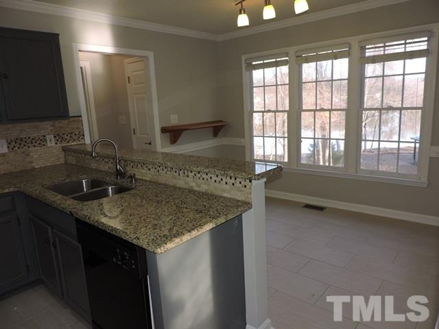 4325 Willow Lake Road Raleigh, NC 27616 - Photo 8 of 25 a kitchen with a sink and a mirror