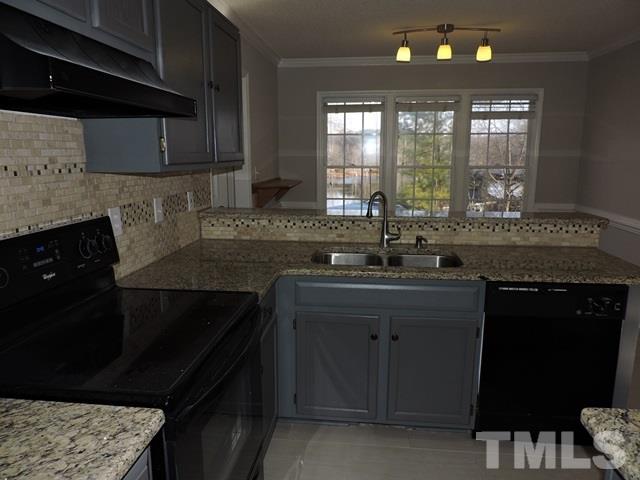 4325 Willow Lake Road Raleigh, NC 27616 - Photo 9 of 25 a kitchen with a sink stove and cabinets