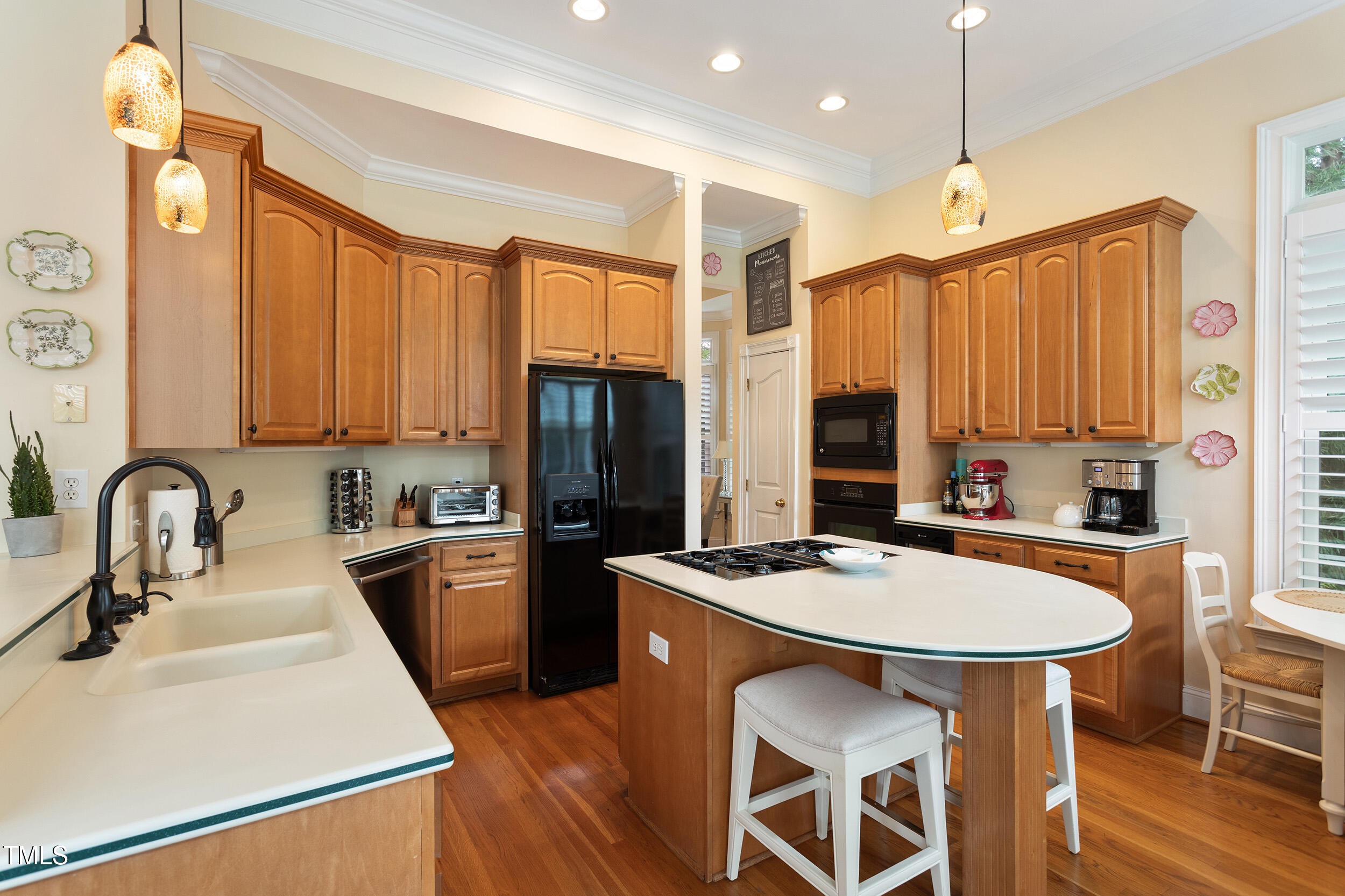 3928 Bentley Bridge Road Raleigh, NC 27612 - Photo 15 of 36 a kitchen with stainless steel appliances a dining table chairs stove refrigerator and sink