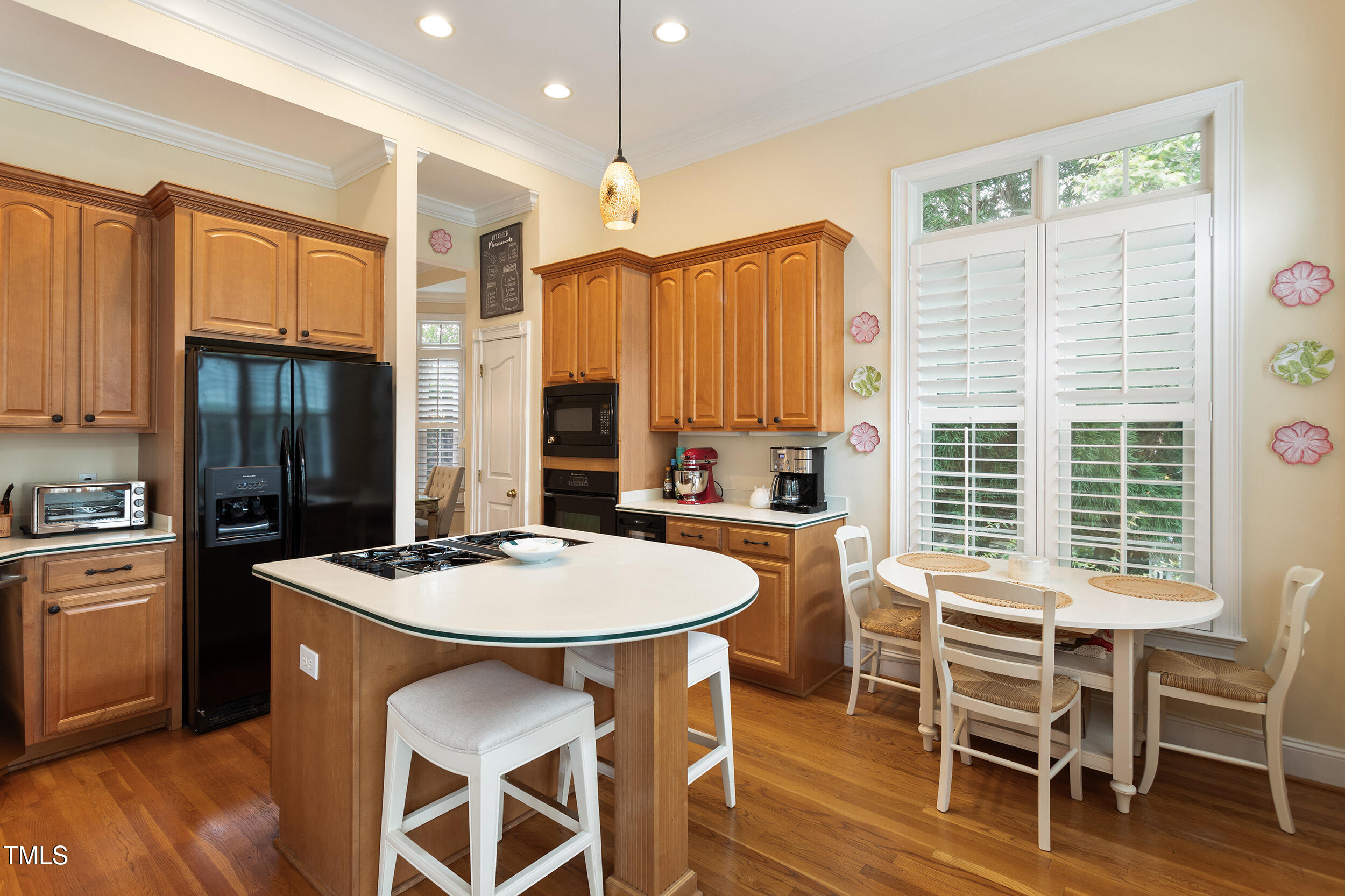 3928 Bentley Bridge Road Raleigh, NC 27612 - Photo 16 of 36 a kitchen with a table chairs stove and refrigerator