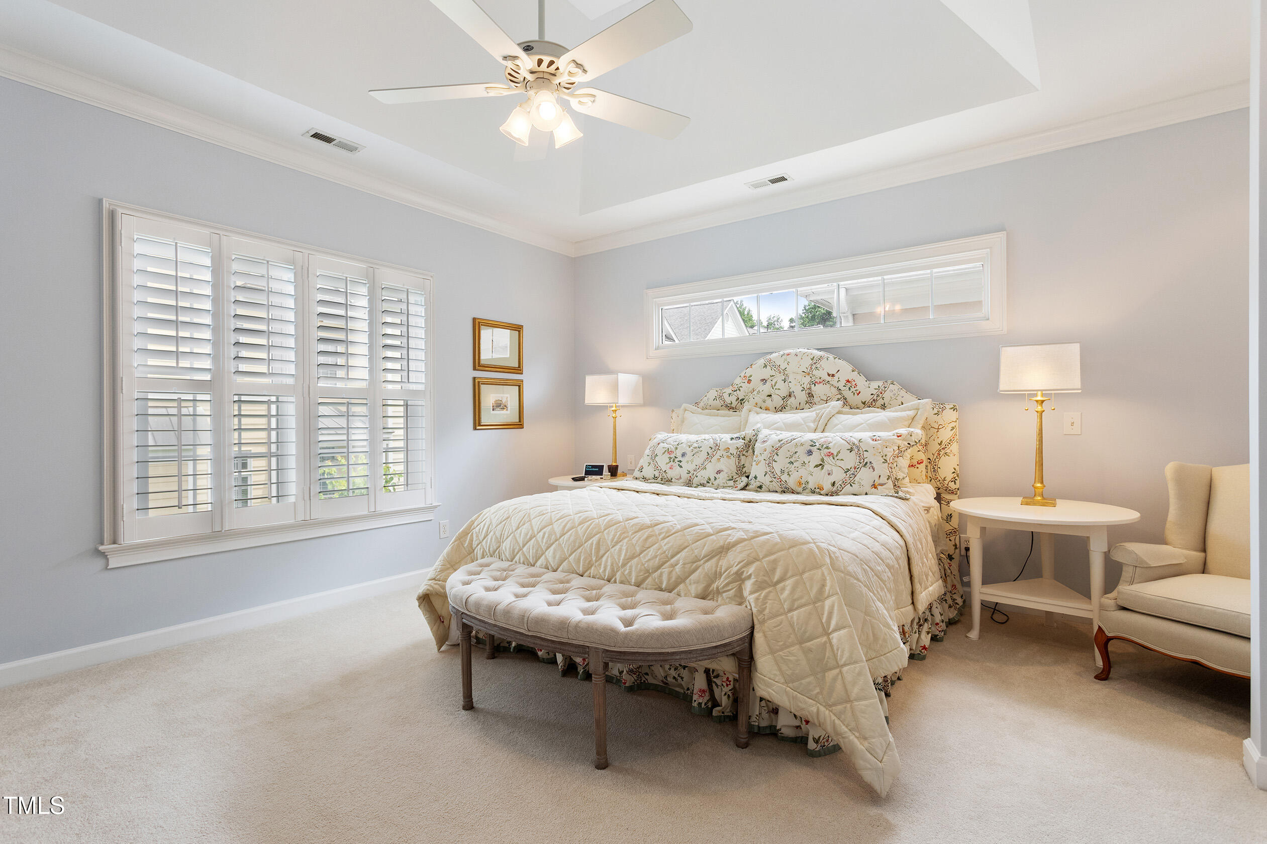 3928 Bentley Bridge Road Raleigh, NC 27612 - Photo 19 of 36 a spacious bedroom with a bed and a chandelier