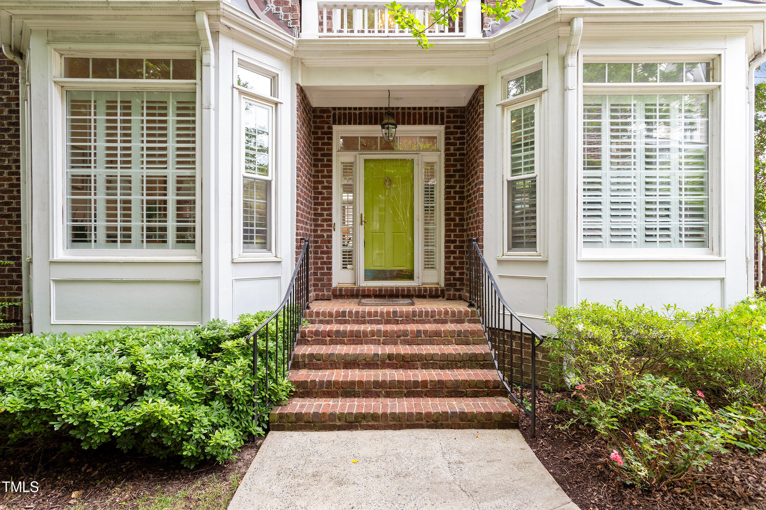 3928 Bentley Bridge Road Raleigh, NC 27612 - Photo 2 of 36 a view of a house with potted plants and a bench in front of door
