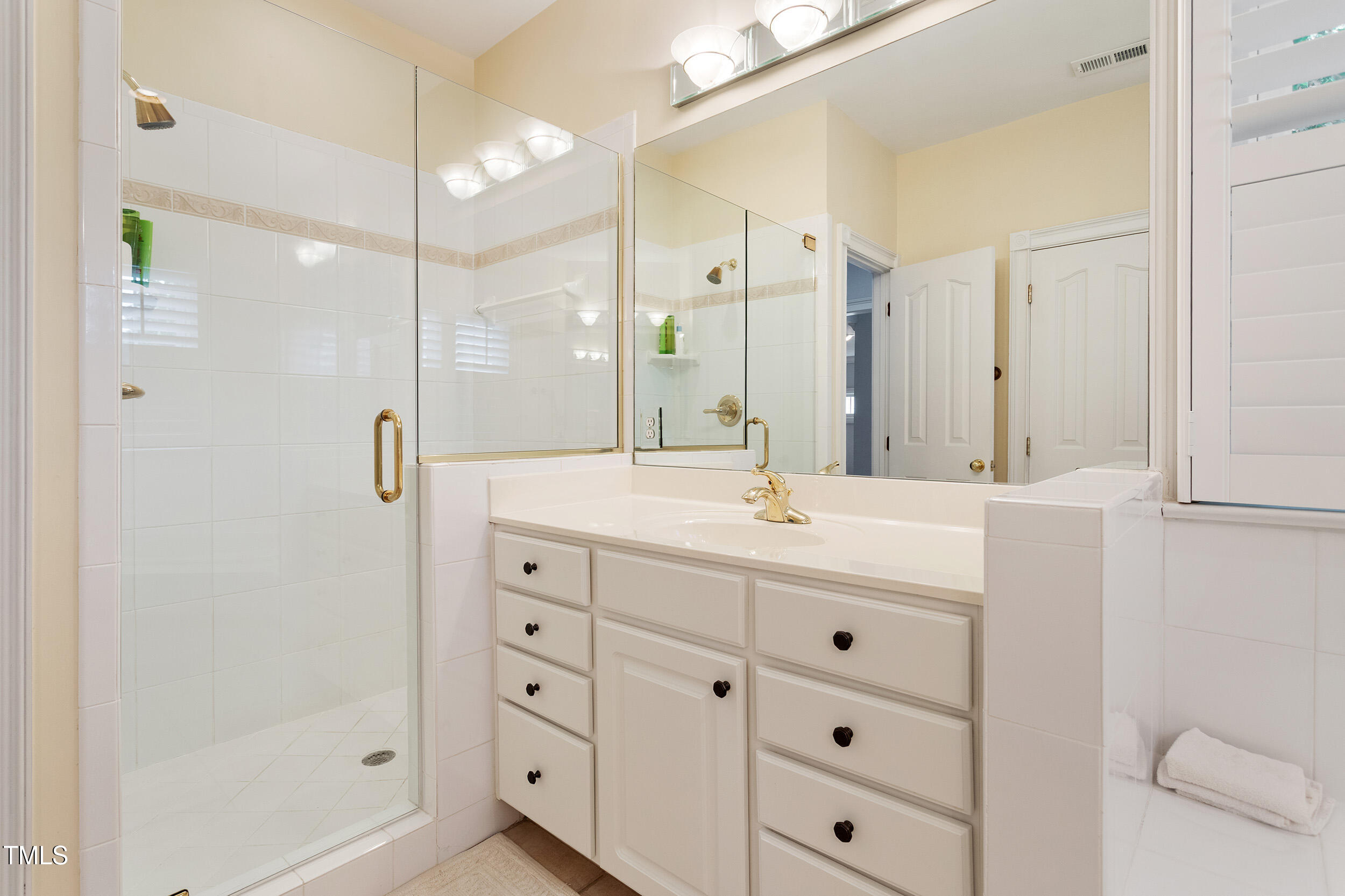 3928 Bentley Bridge Road Raleigh, NC 27612 - Photo 24 of 36 a bathroom with a double vanity sink mirror and shower