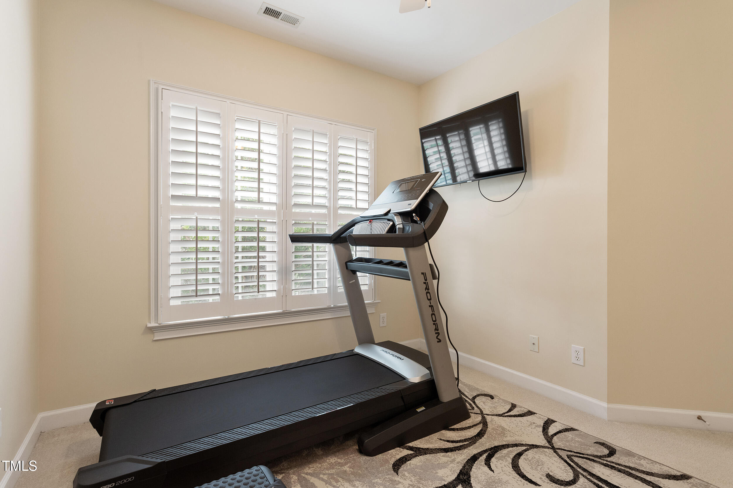 3928 Bentley Bridge Road Raleigh, NC 27612 - Photo 29 of 36 a room with gym equipment and a window