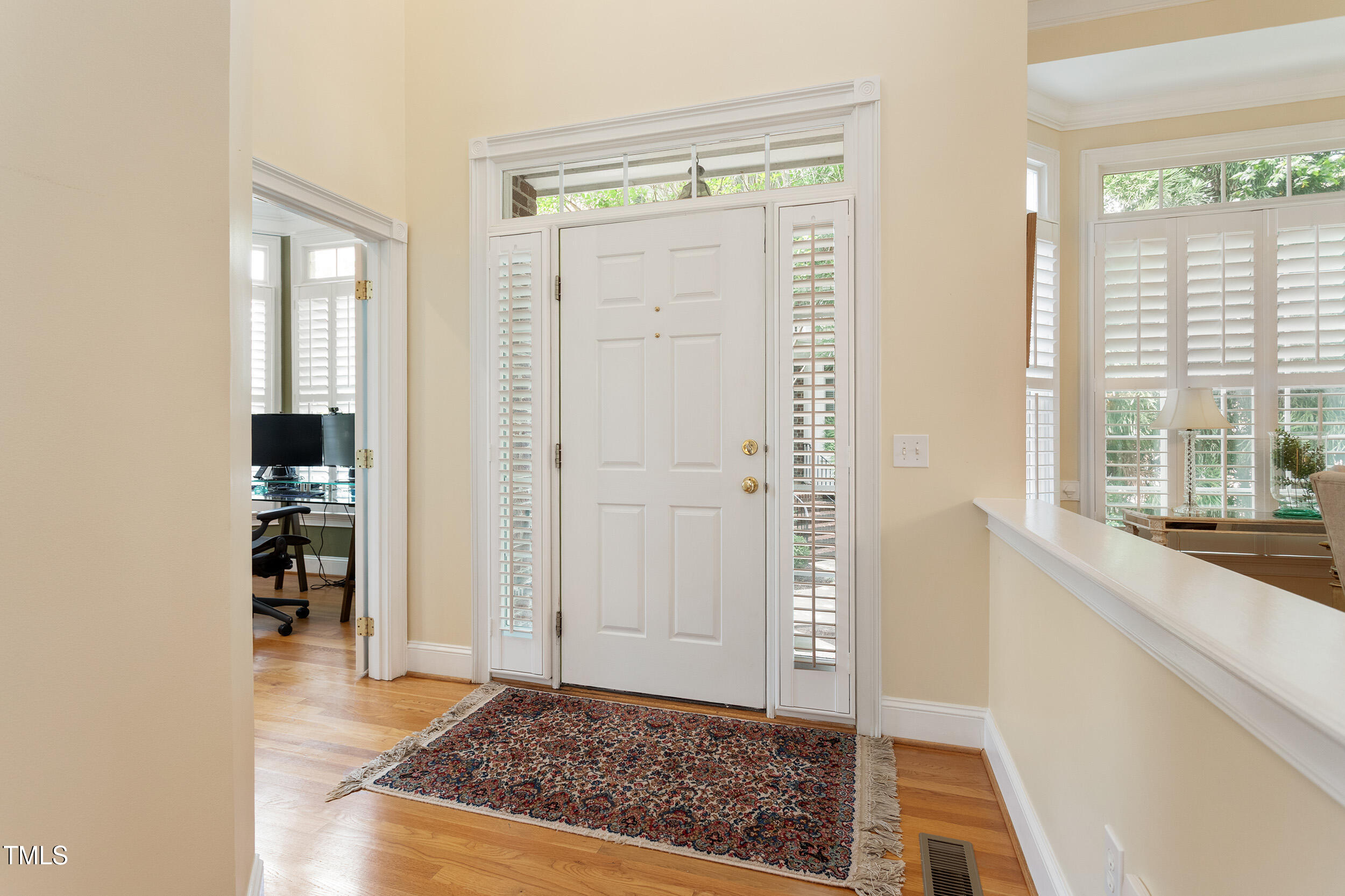 3928 Bentley Bridge Road Raleigh, NC 27612 - Photo 3 of 36 a view of a hallway with wooden floor and a living room