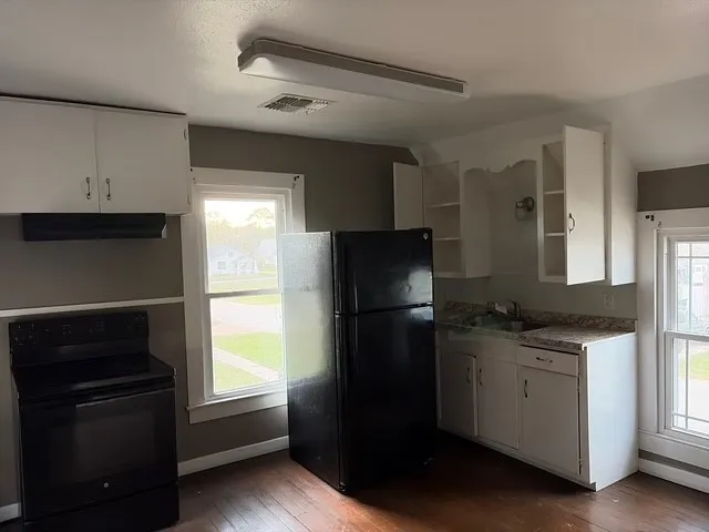 a kitchen with a refrigerator stove and sink
