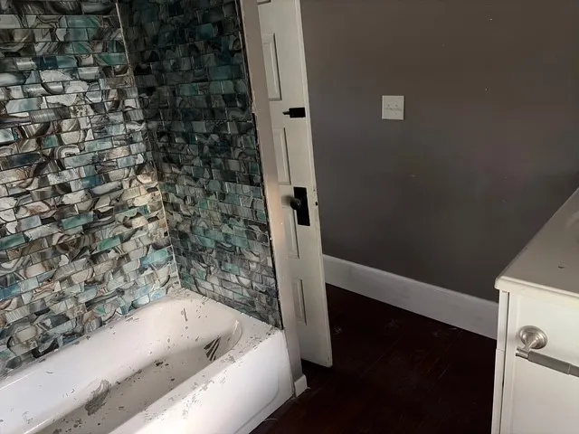 a bathroom with a bathtub and a shower