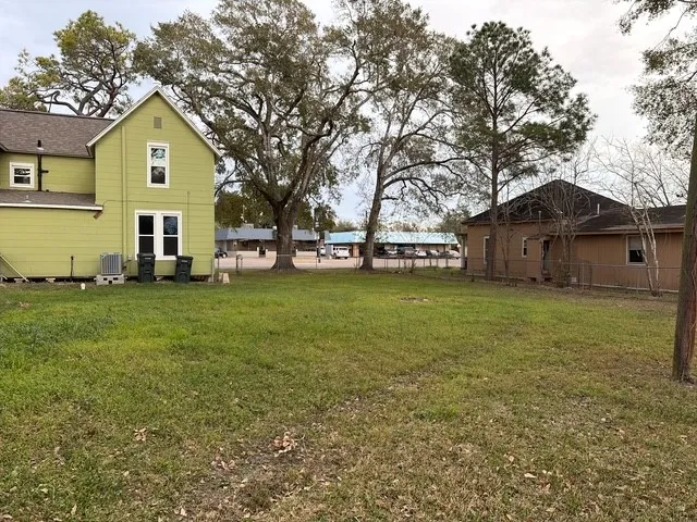 a front view of a house with a garden and trees