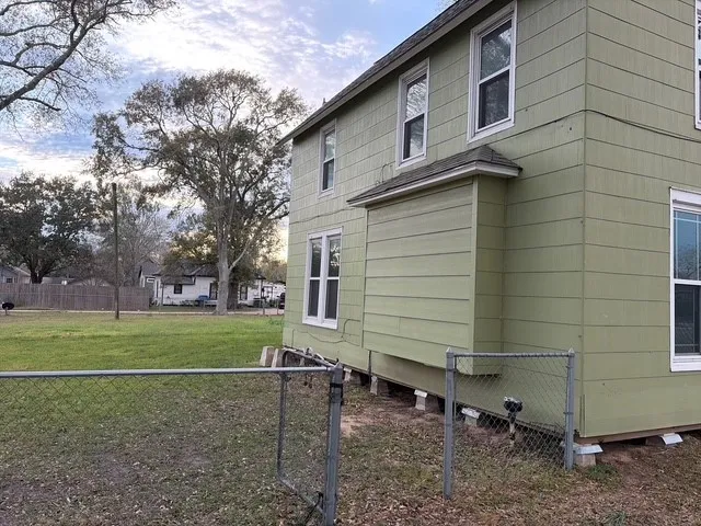 a view of a backyard with large trees