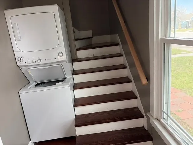 a view of washer and dryer with wooden floor
