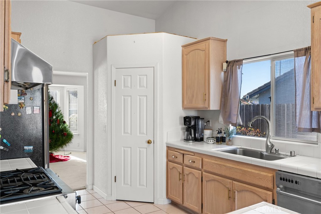 781 Koval Lane Santa Maria, CA 93455 - Photo 17 of 33 a kitchen with sink refrigerator and stove