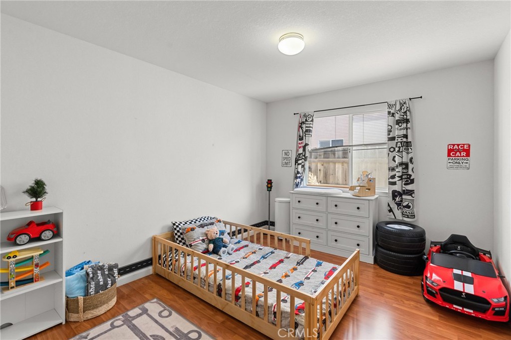 781 Koval Lane Santa Maria, CA 93455 - Photo 22 of 33 a bedroom with furniture and a wooden floor