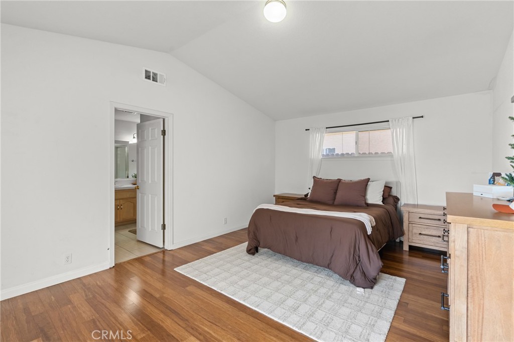 781 Koval Lane Santa Maria, CA 93455 - Photo 24 of 33 a bedroom with a bed and wooden floor