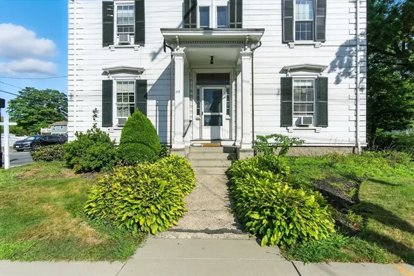 front view of a house with potted plants