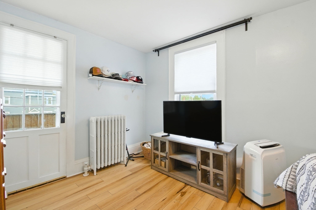 35 Locust Street, Unit 3 Danvers, MA 01923 - Photo 19 of 42 a view of a livingroom with furniture and a flat screen tv
