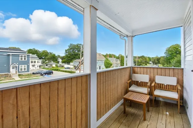 a view of a balcony with wooden floor