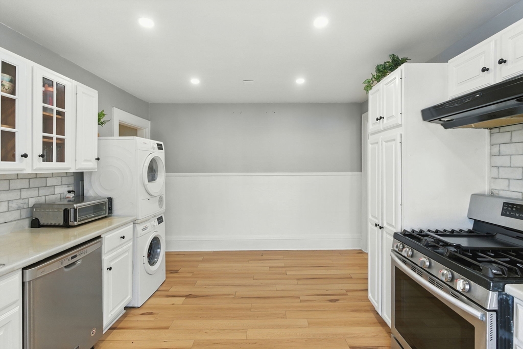 35 Locust Street, Unit 3 Danvers, MA 01923 - Photo 25 of 42 a kitchen with stainless steel appliances granite countertop a stove and a refrigerator