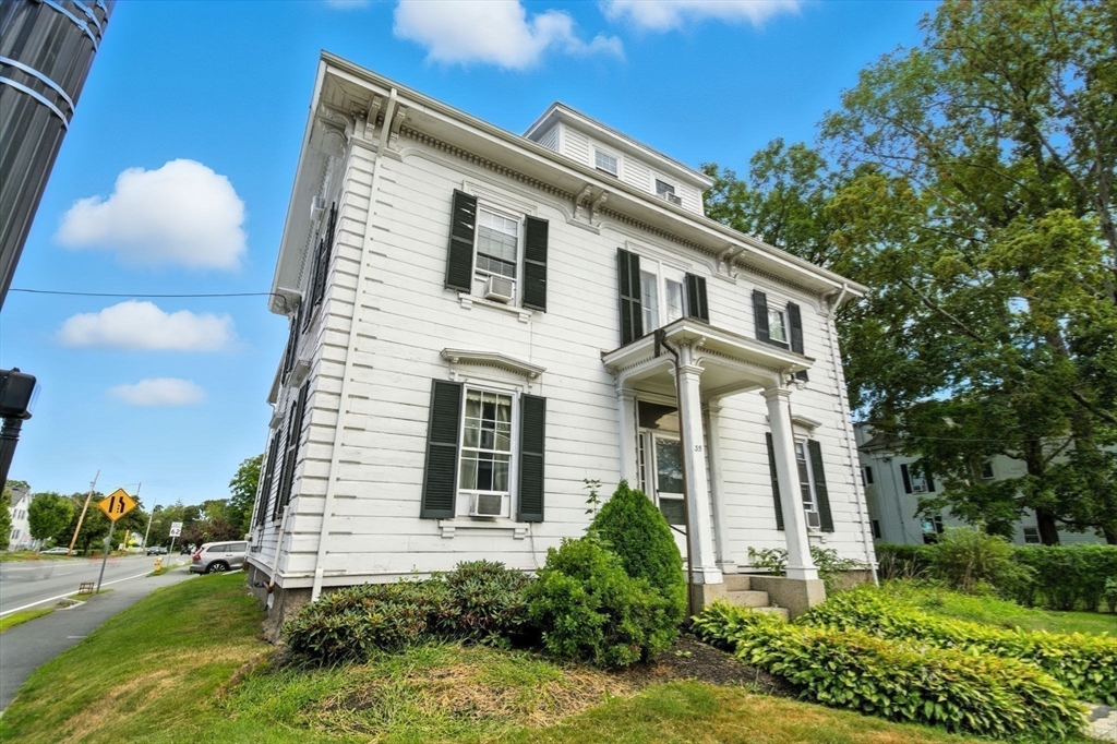 35 Locust Street, Unit 3 Danvers, MA 01923 - Photo 26 of 42 a front view of a house with a yard