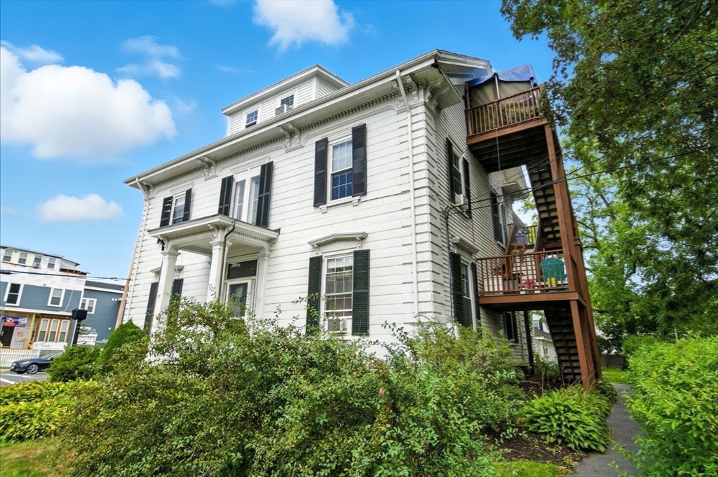 35 Locust Street, Unit 3 Danvers, MA 01923 - Photo 27 of 42 a front view of a house with a garden