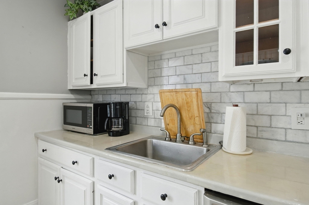 35 Locust Street, Unit 3 Danvers, MA 01923 - Photo 28 of 42 a kitchen with sink a microwave and cabinets