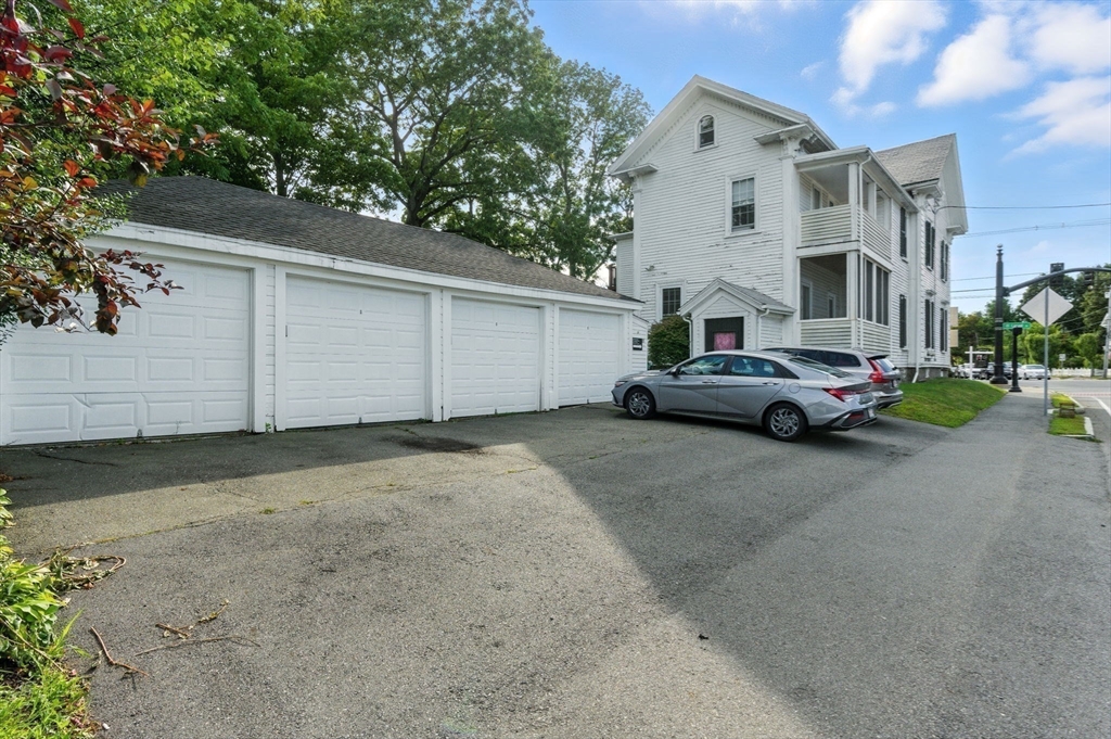 35 Locust Street, Unit 3 Danvers, MA 01923 - Photo 9 of 42 a car parked in front of white house