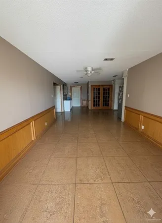 a large kitchen with granite countertop a refrigerator and a stove top oven