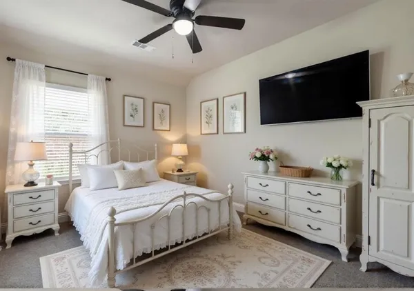 a spacious bedroom with a bed and a flat screen tv