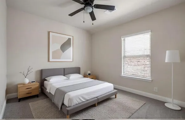 a bedroom with a bed and a window