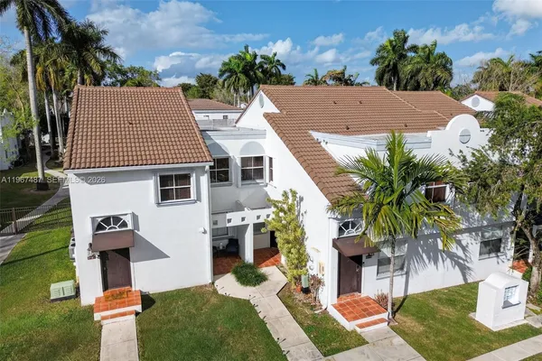 a aerial view of a house with a yard and potted plants