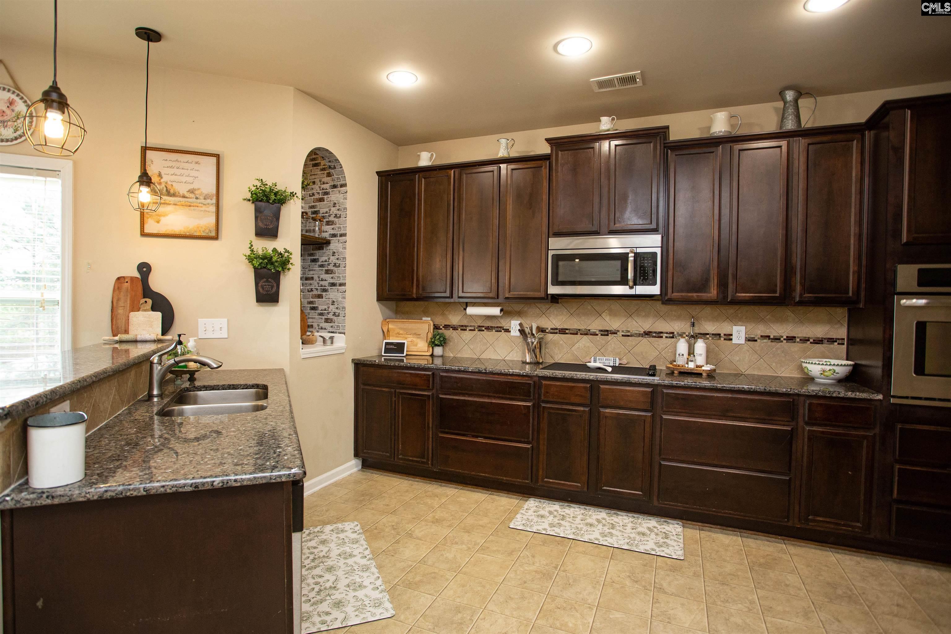 7 Templand Court Elgin, SC 29045 - Photo 15 of 47 a kitchen with granite countertop a sink stainless steel appliances and cabinets