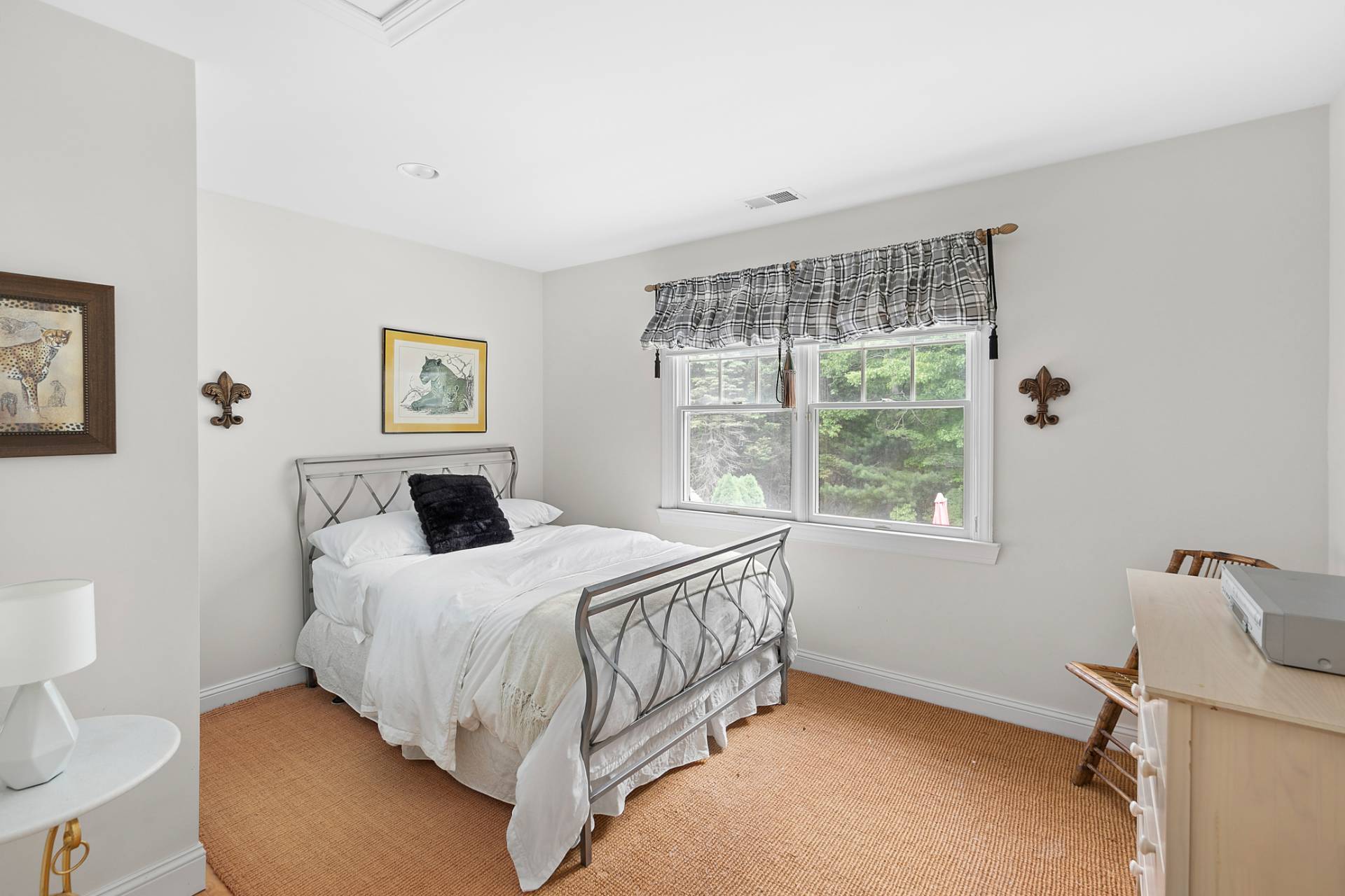 1557 Millstone Road Sag Harbor, NY 11963 - Photo 7 of 12 a bedroom with a bed a mirror and a window