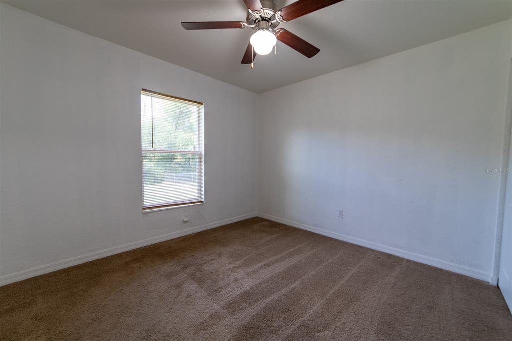 5107 Southwest 165th St Road Ocala, FL 34473 - Photo 22 of 34 an empty room with a window and a fan